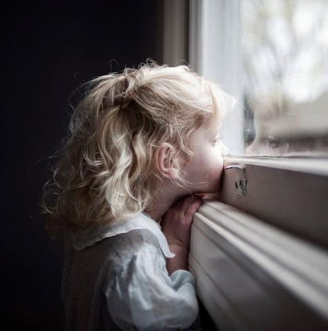 picture of a girl looking out the window